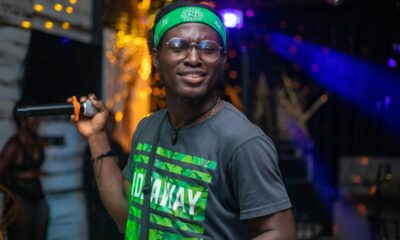 Ghanaian rapper performing on stage, illustrating Okyeame Kwame's Citi Business Olympics appearance
