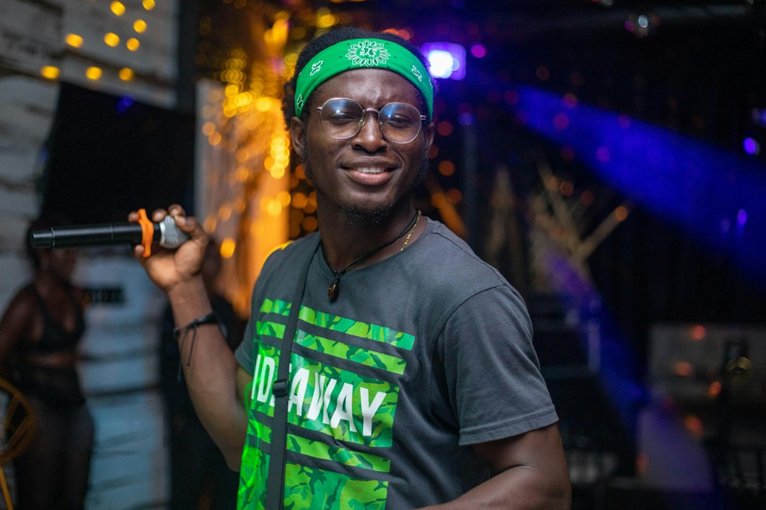 Ghanaian rapper performing on stage, illustrating Okyeame Kwame's Citi Business Olympics appearance